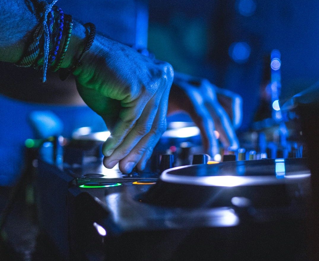 man controlling DJ controller