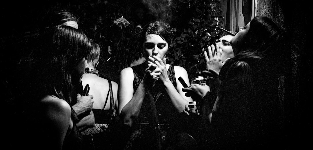 four women smoking together four women smoking together