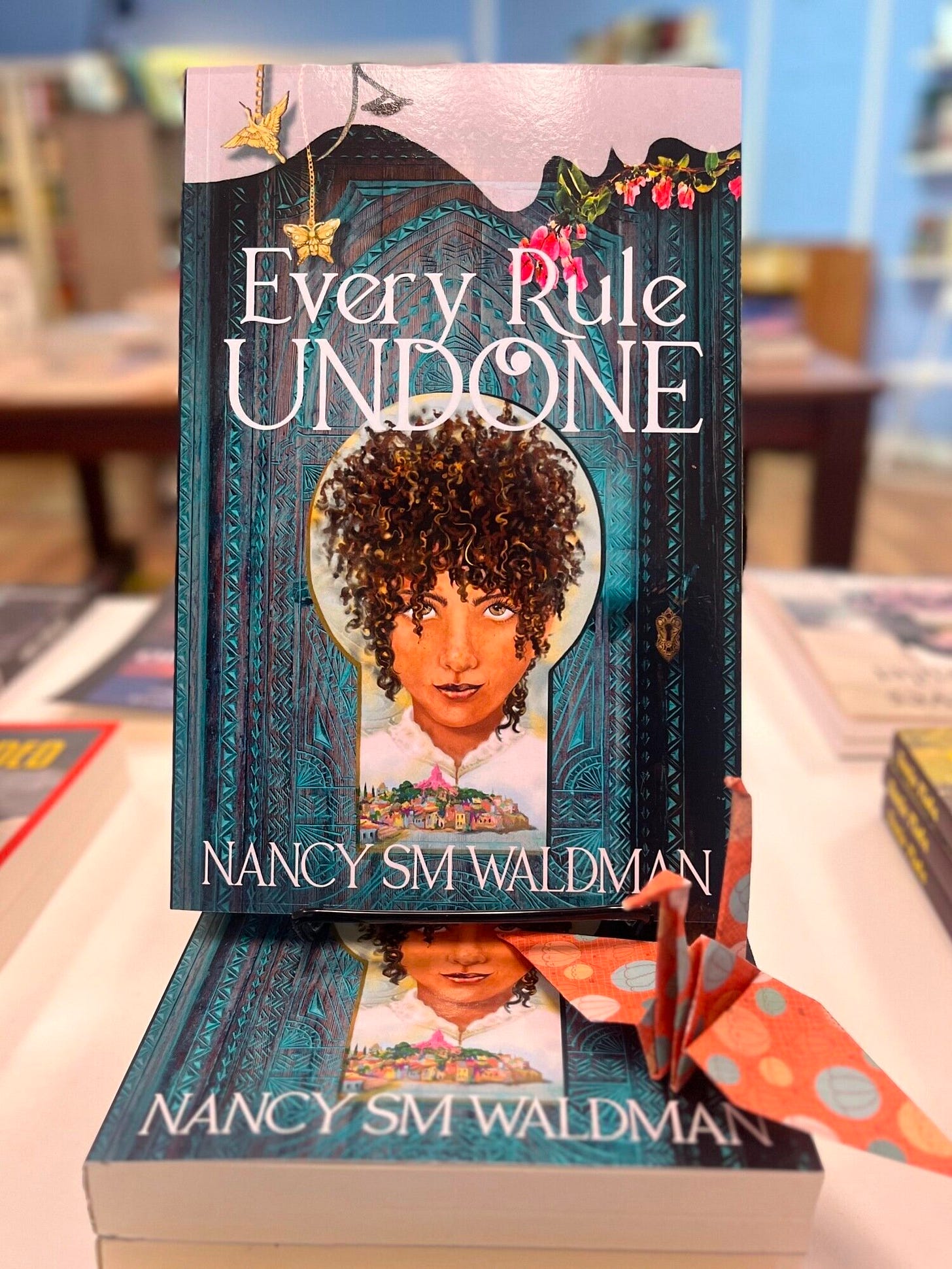 Copies of Every Rule Undone displayed in On the Same Page Bookstore