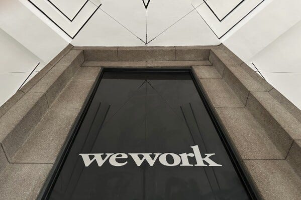 The WeWork logo appears on a building exterior in New York on Tuesday, Nov. 7, 2023. WeWork has filed for Chapter 11 bankruptcy protection, marking a stunning fall for the office sharing company once seen as a Wall Street darling that promised to upend the way people went to work around the world. (AP Photo/Peter Morgan)