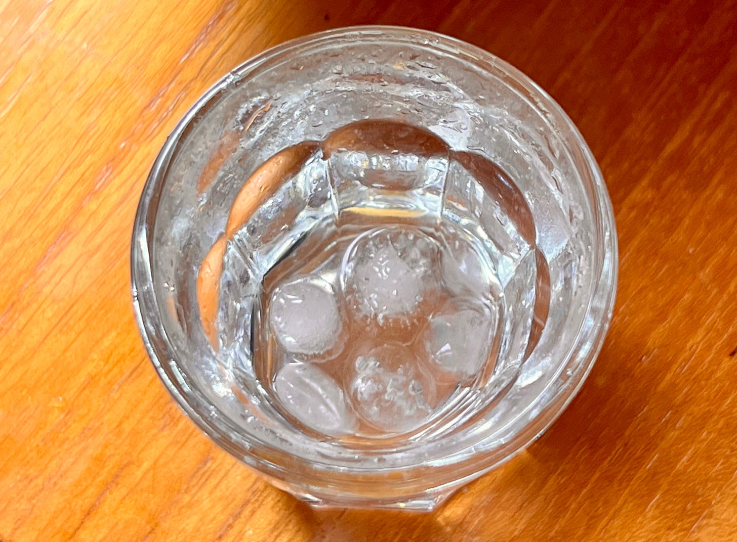 An overhead image of a shot glass with the reminanse of some sluice in the bottom