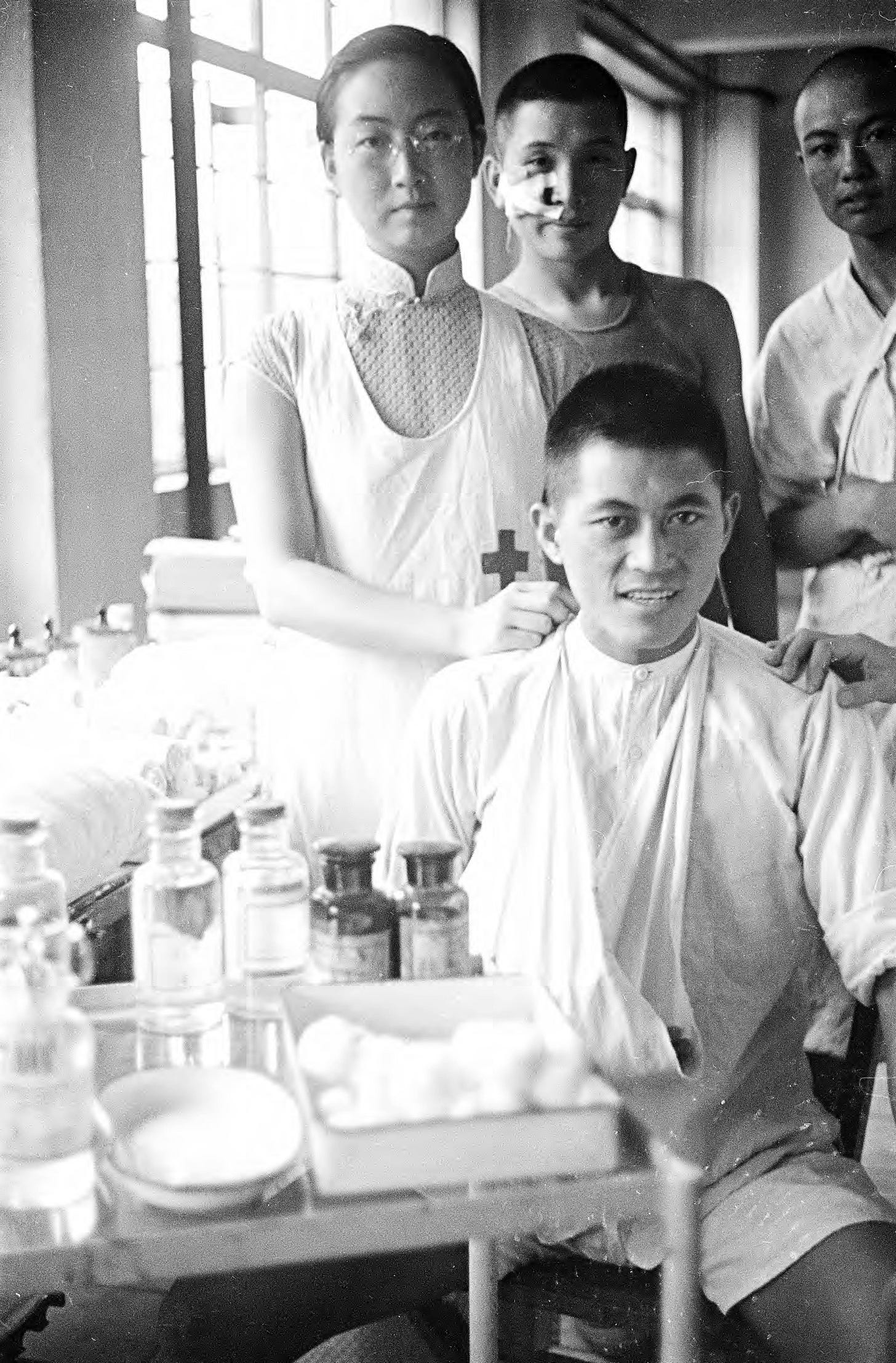 Medical staff diligently attending to a patient in a Shanghai hospital during the Second Sino-Japanese War, 1937, captured by Harrison Forman. Medical staff diligently attending to a patient in a Shanghai hospital during the Second Sino-Japanese War, 1937, captured by Harrison Forman.