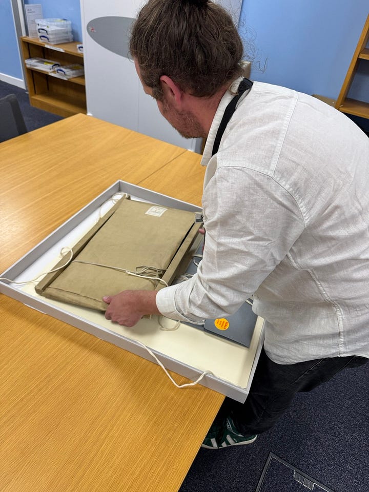 Dr Euan Roger removing Anne Boleyn's trial document from its protective package