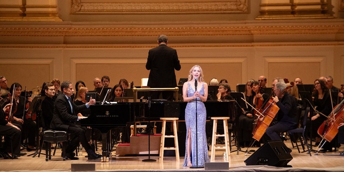 The inspiration for this piece: Seth Rudetsky at the piano and Kerry Butler at the mic, backed by the South Shore Symphony, during Seth Rudetsky and Friends at Carnegie Hall