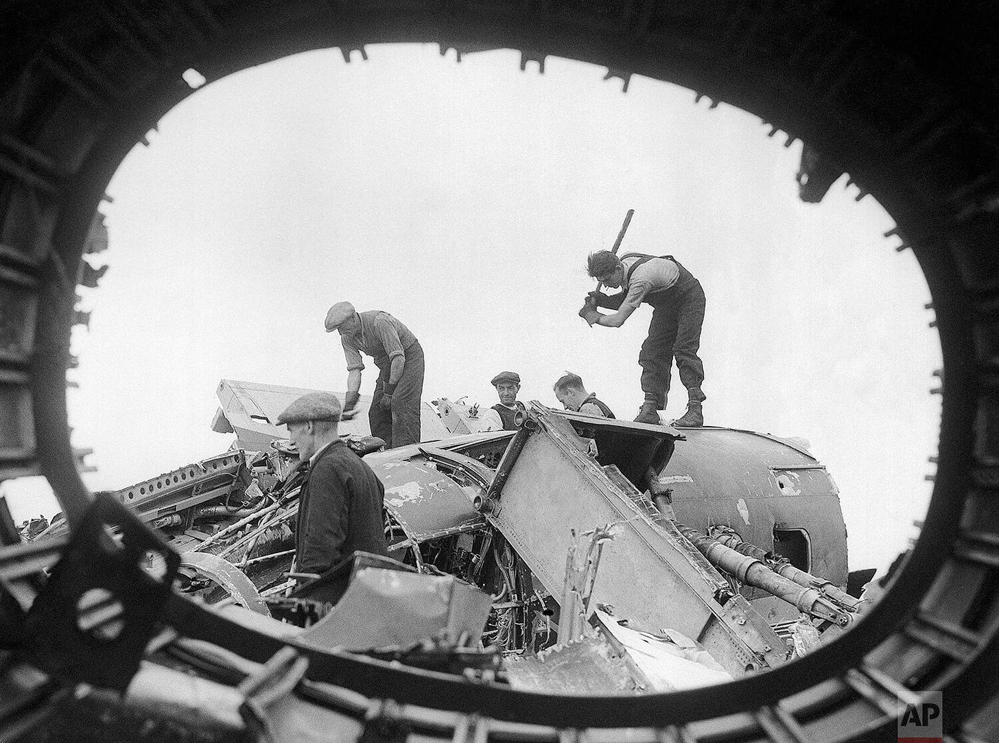 British salvage workers meticulously dismantle the wreckage of downed German raiders in a salvage yard on August 26, 1940, repurposing the remains of enemy aircraft shot down over England. British salvage workers meticulously dismantle the wreckage of downed German raiders in a salvage yard on August 26, 1940, repurposing the remains of enemy aircraft shot down over England.