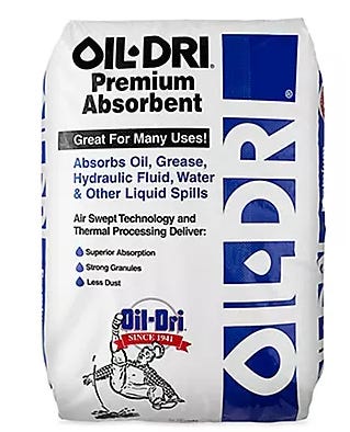 Bag of Oil-Dri Premium Absorbent showing product label that highlights absorption of oil, grease, hydraulic fluid, water and other spills — featured in an Oil-Dri Corporation of America (ODC) deep dive article about industrial absorbents and specialty clay products.