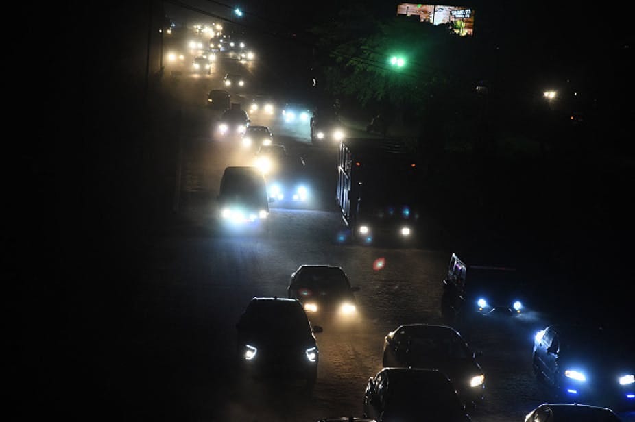Cars with their headlamps on at night. Cars with their headlamps on at night.