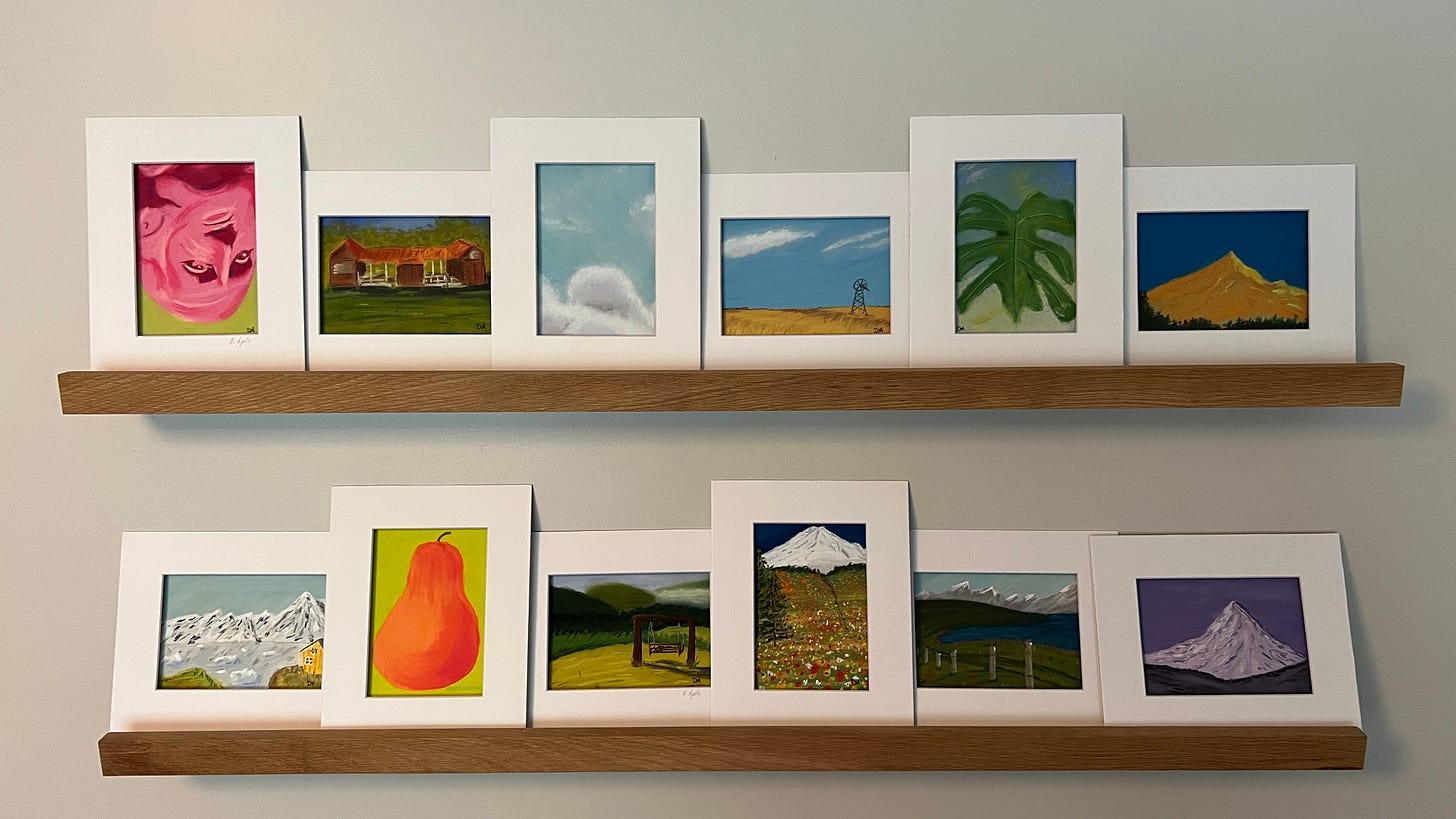Photos of soft pastel art on two picture shelves. Many themes and multiple colors present