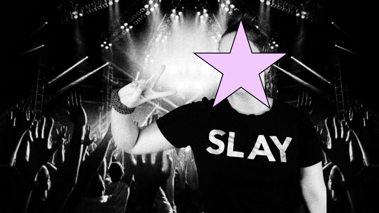 A concert with lights and a crowd. Black and white. Person in front with t-shirt saying 'slay'