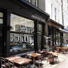 A restaurant with tables and chairs outside

Description automatically generated