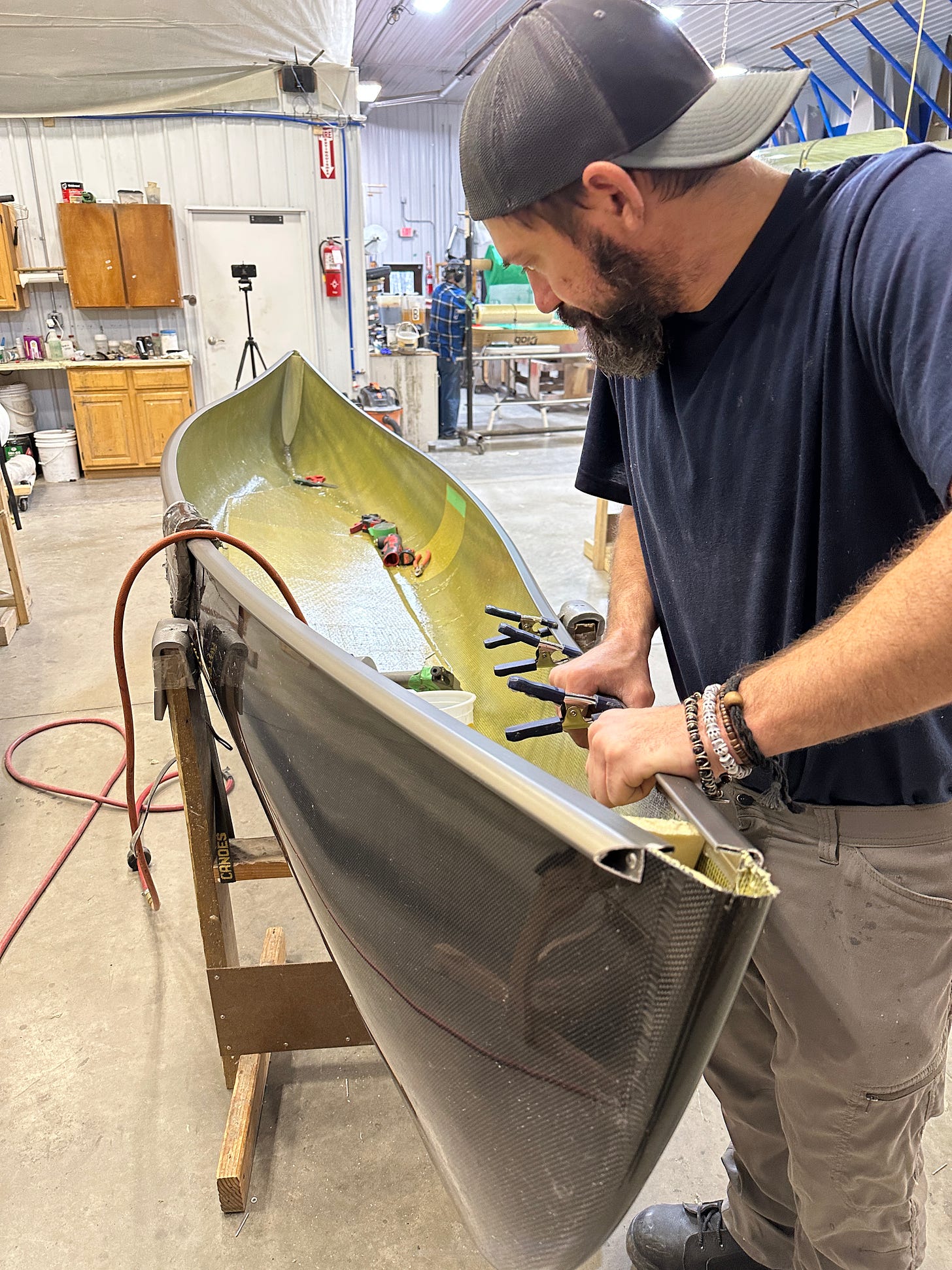 Putting gunwales on a canoe.