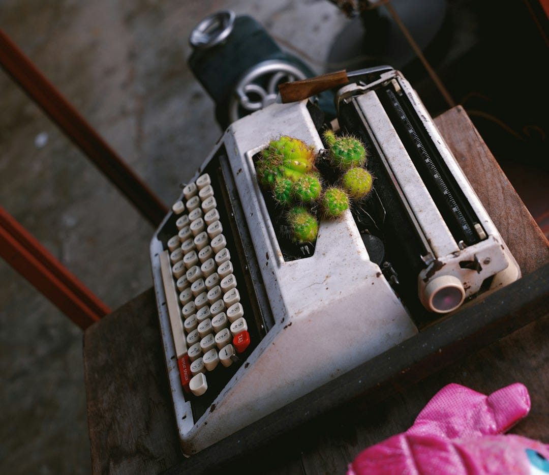 A typewriter sitting on top of a wooden table