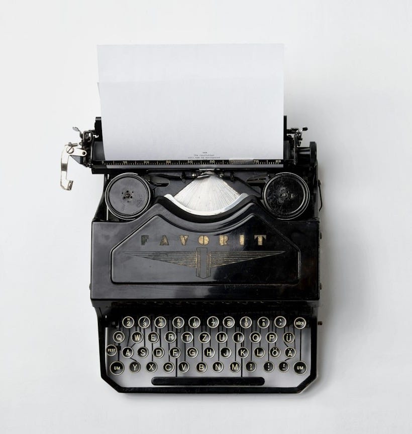 black Fayorit typewriter with printer paper