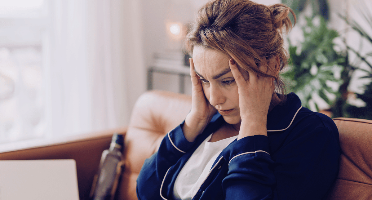 Overwhelmed woman staring at a laptop screen Overwhelmed woman staring at a laptop screen