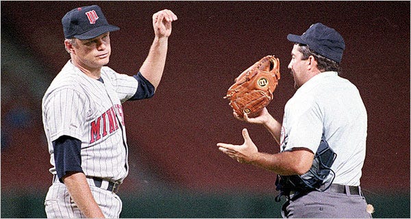 Niekro turns over his glove for inspection.