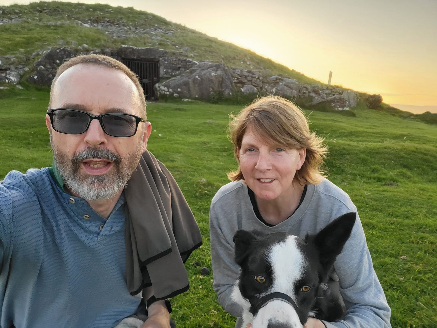 Man, woman & dog at Loughcrew megalithic site in Ireland at sunset