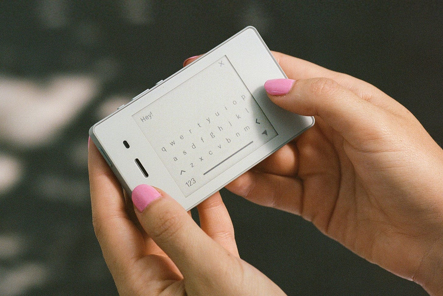 A person texting with a Light Phone II.