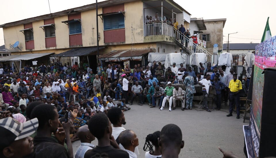A large crowd of football fans watches an Afcon quarterfinal on an outdoor screen in Lagos. A large crowd of football fans watches an Afcon quarterfinal on an outdoor screen in Lagos.