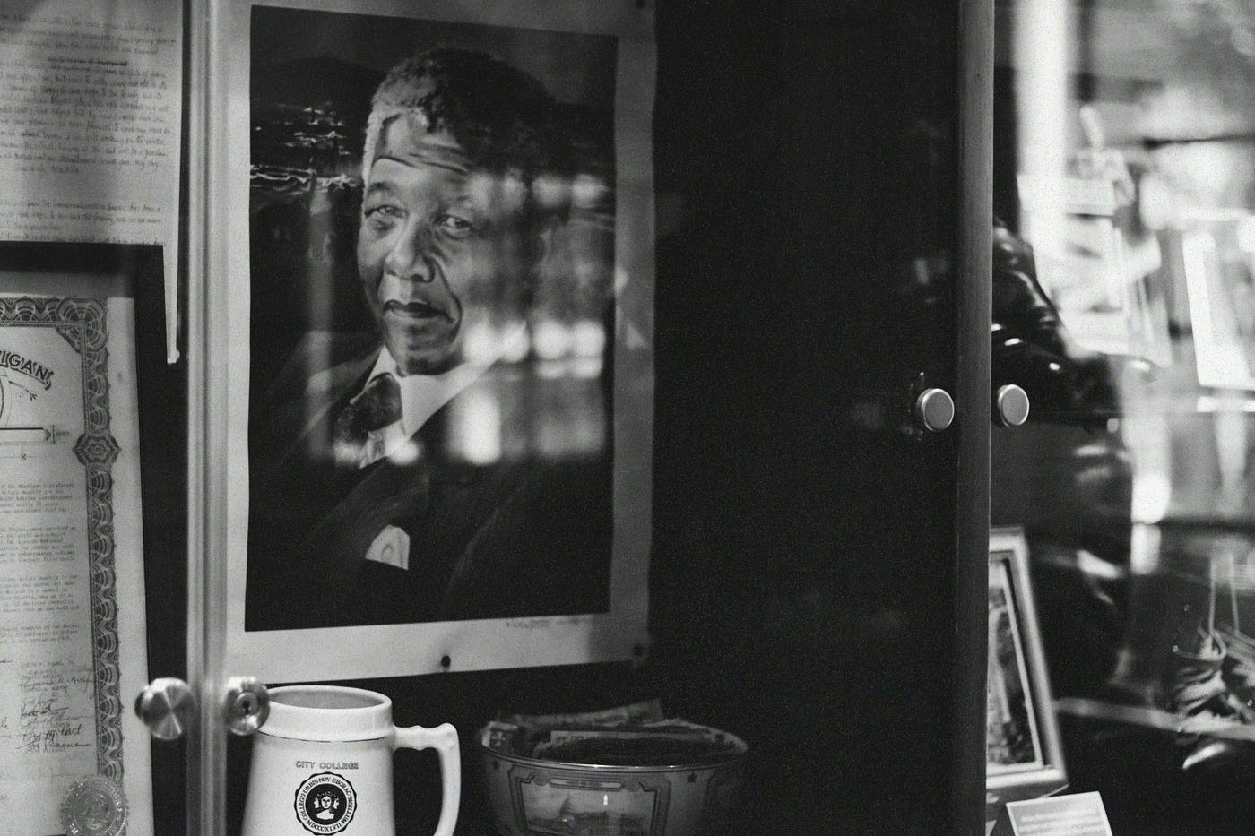 A black and white picture of Nelson Mandela in the background. A black and white picture of Nelson Mandela in the background.