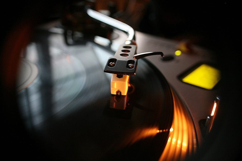 Record deck arm on a vinyl record