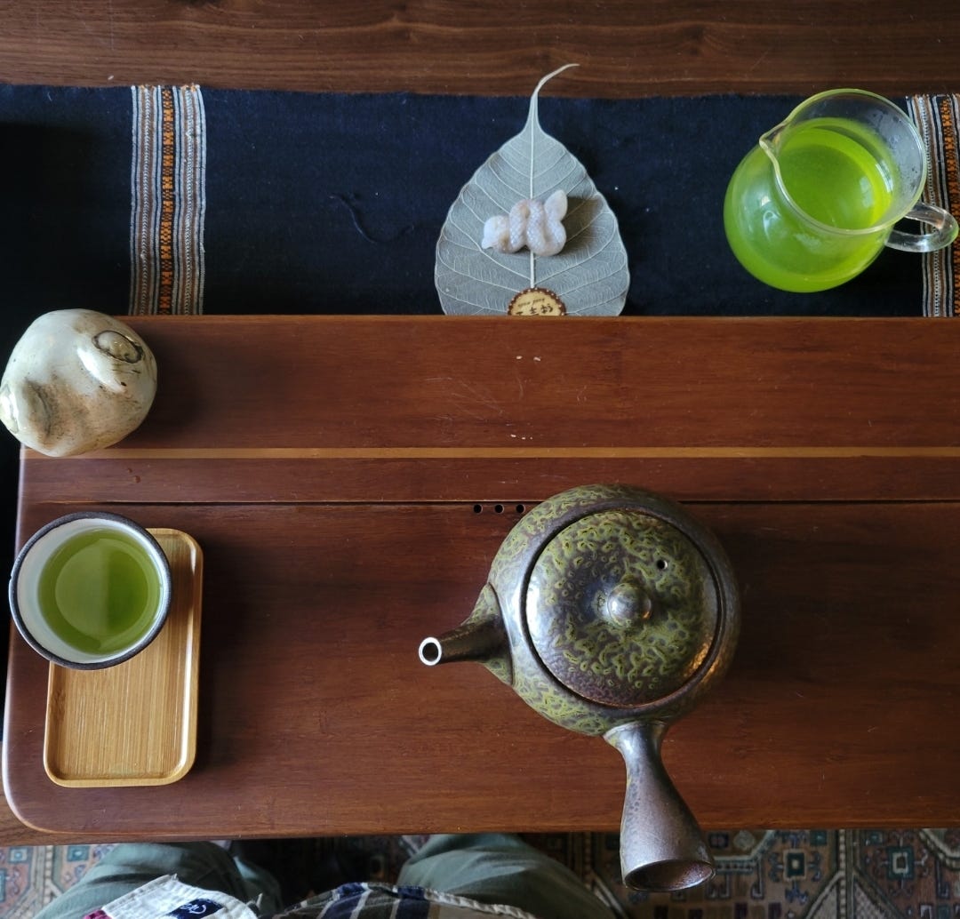 a tea setup with a pitcher, cup, & japanese teapot a tea setup with a pitcher, cup, & japanese teapot