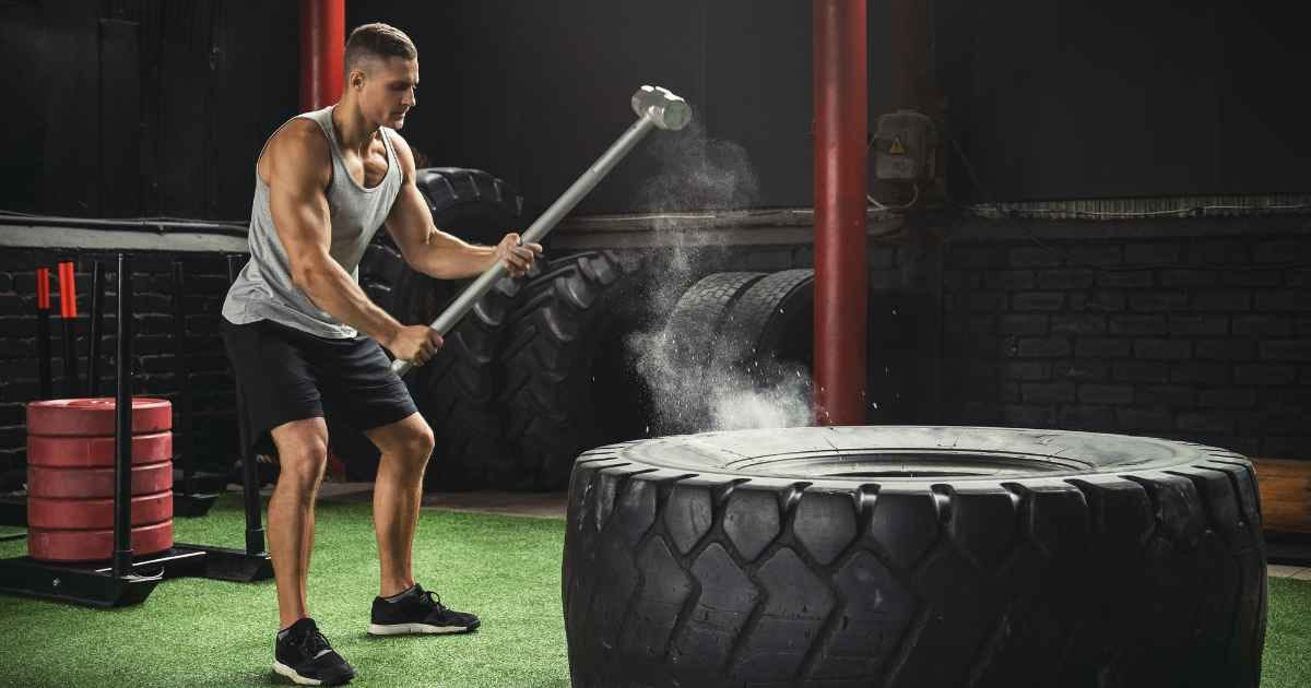 Man hitting tire with sledgehammer 