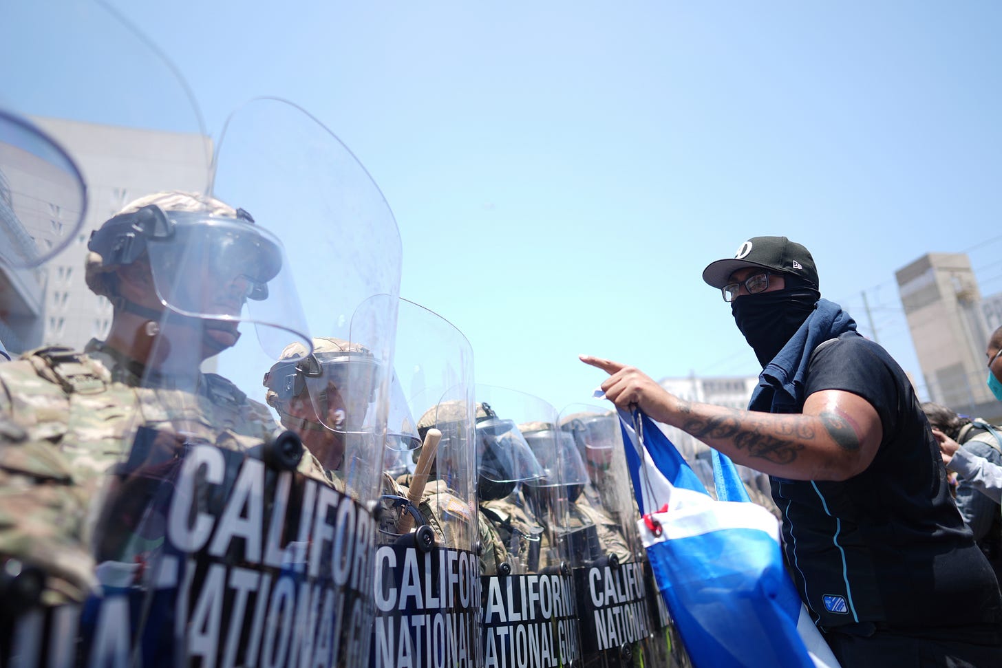 A protester confronts a line of U.S. National Guard near the metropolitan detention center of downtown Los Angeles on Sunday.