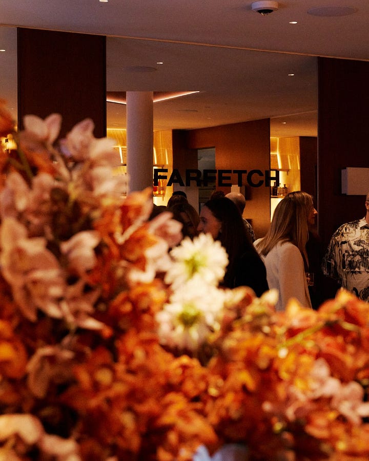 Guests among floral displays and a DJ at FARFETCH’s New York Fashion Week gathering.
