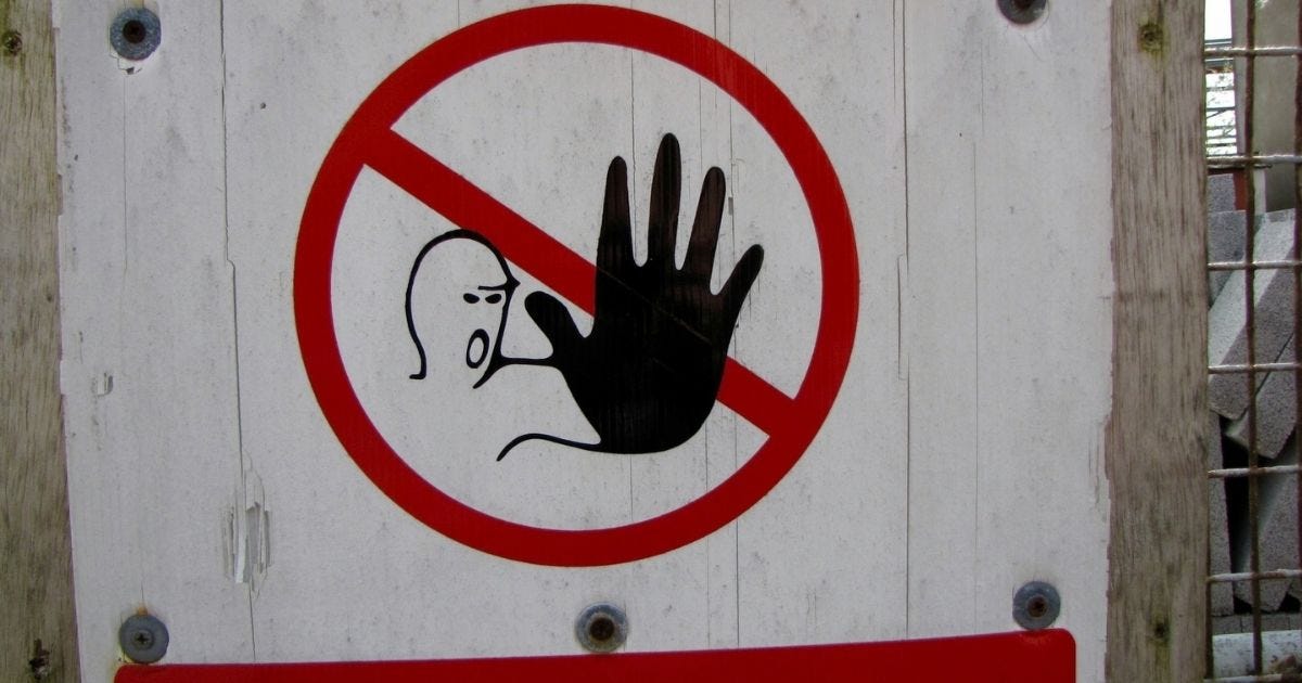 Stop sign with a man gesturing with his hand no Stop sign with a man gesturing with his hand no