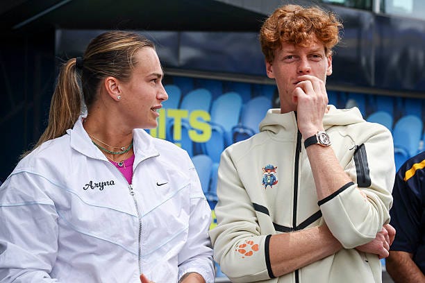 Current Australian Open tennis champions Aryna Sabalenka of Belarus and Italy's Jannik Sinner talk as they wait to participate in an offical ceremony...