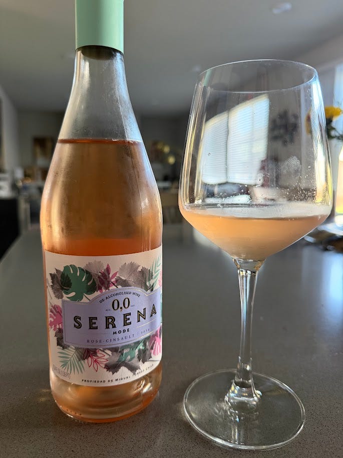 Two more non-alcoholic pours: MaraBela Wild Verbena Sparkling Tea poured beside its cork, and Serena Mode Rosé-Cinsault, a pale pink de-alcoholised wine, poured into a stemmed glass.