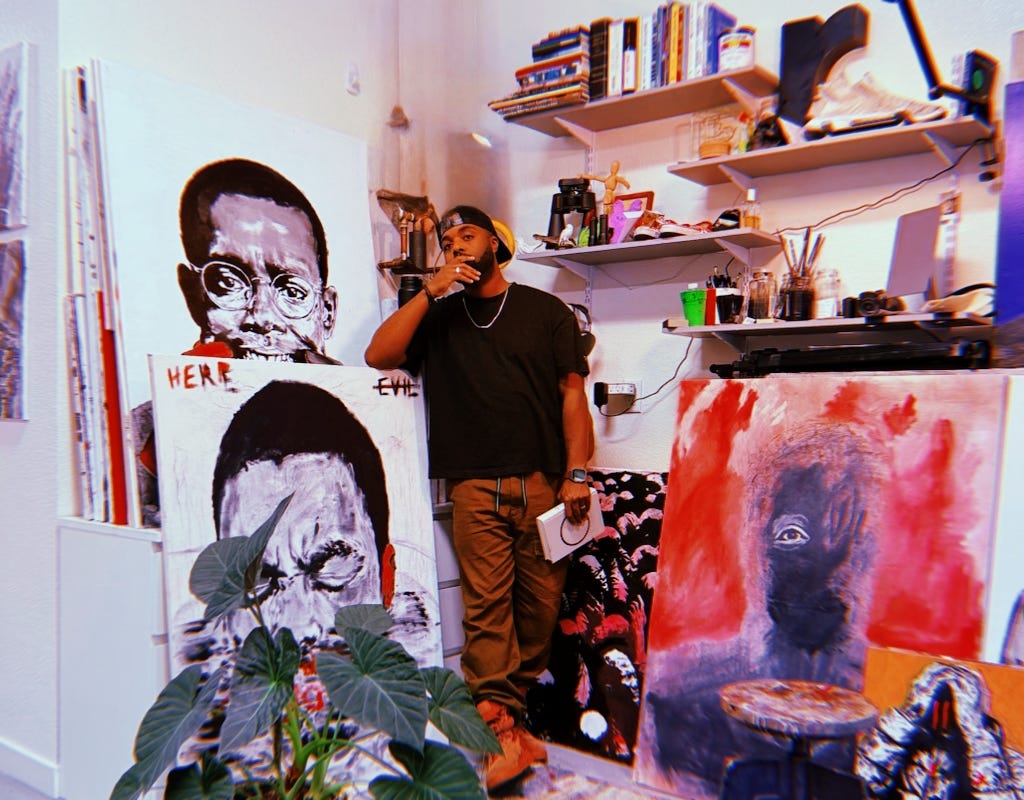Robert stands in his studio surrounded by his art that ranges from black and white to color. With his hand on his face he ponders what his upcoming show will mean to him.