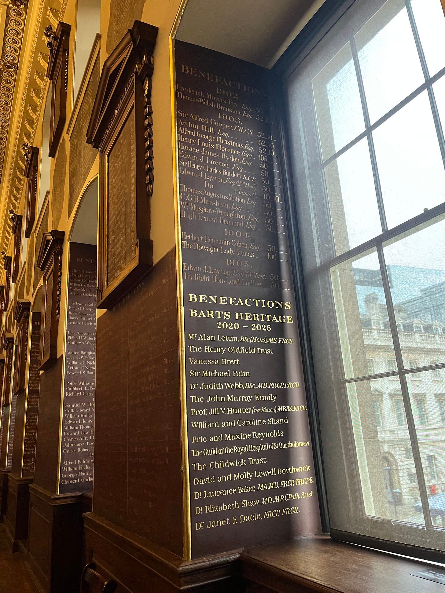 Part of the wall of Barts North Wing with donors from 1902-1905 and 2020-2025 inscribed on the wall. Part of the wall of Barts North Wing with donors from 1902-1905 and 2020-2025 inscribed on the wall.