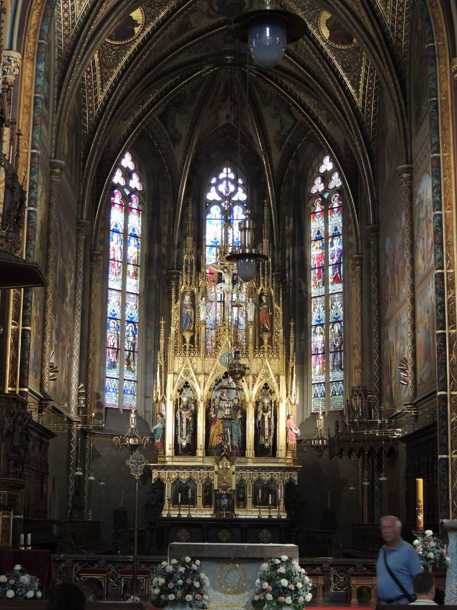 A large ornate building with stained glass windows

AI-generated content may be incorrect.