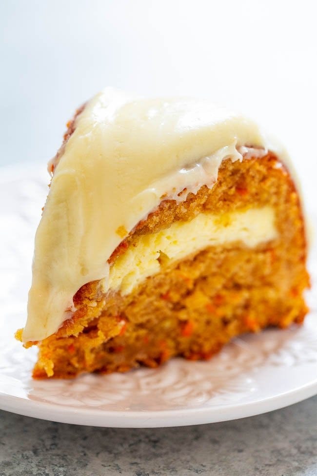A silce of Carrot Apple Cream Cheese Tunnel Cake with Cream Cheese Frosting on a plate. 