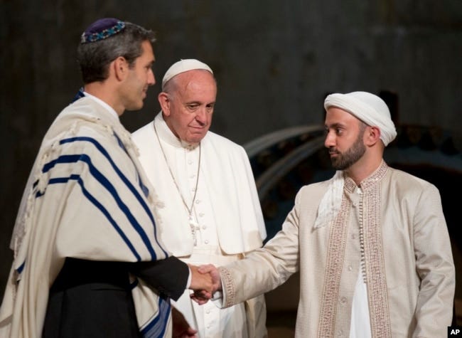 Pope Francis looks at Imam Khalid Latif, right, and Rabbi Elliot J. Cosgrove, left, shaking hands as he arrives for an interfaith service at the Sept. 11 memorial museum in New York, Sept. 25, 2015. Pope Francis looks at Imam Khalid Latif, right, and Rabbi Elliot J. Cosgrove, left, shaking hands as he arrives for an interfaith service at the Sept. 11 memorial museum in New York, Sept. 25, 2015.