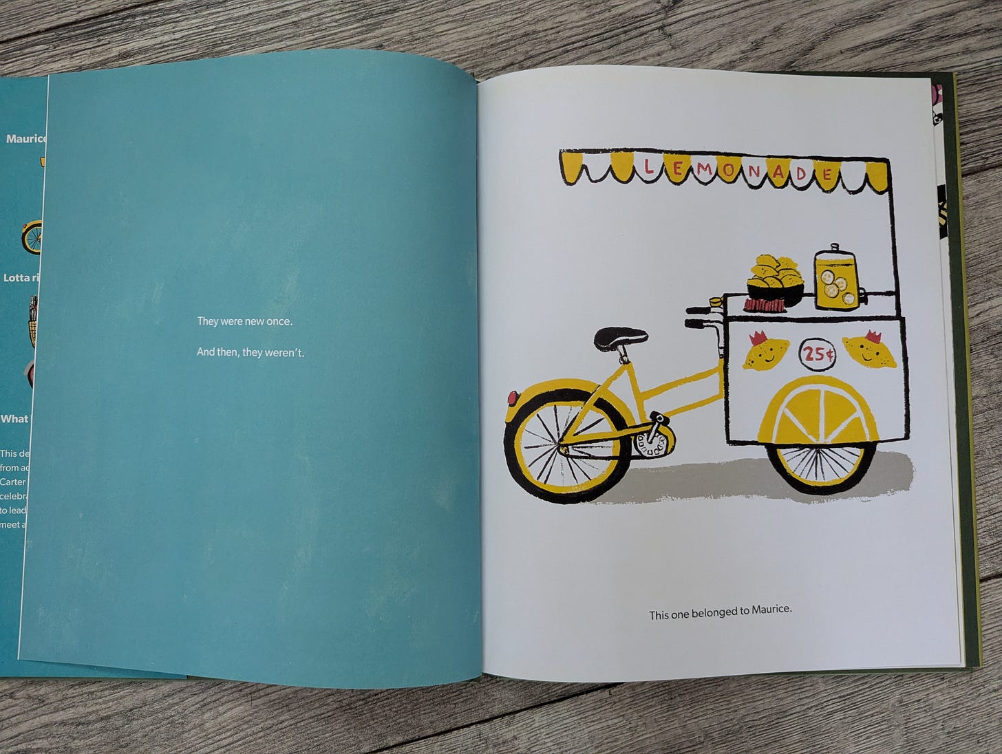 A fancy bicycle with a lemonade stand on the front of it.