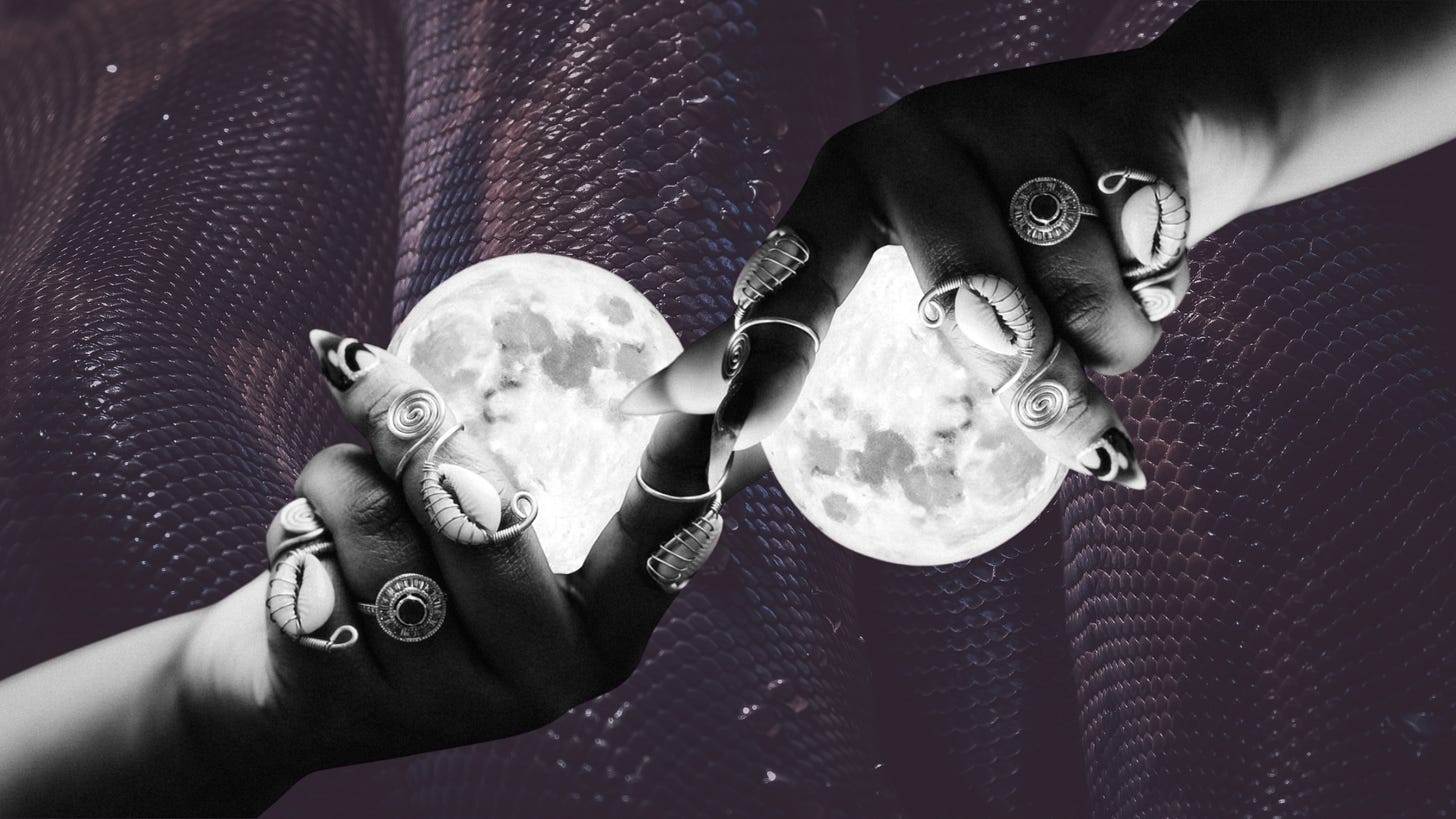 two hands, opposing one another, holding moons on a purple tinged snakeskin two hands, opposing one another, holding moons on a purple tinged snakeskin