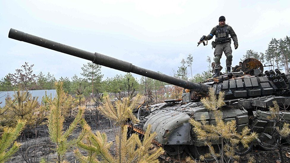 A Ukrainian serviceman stands on the turret of a destroyed Russian army tank not far from the Ukrainian capital of Kyiv on April 3, 2022 A Ukrainian serviceman stands on the turret of a destroyed Russian army tank not far from the Ukrainian capital of Kyiv on April 3, 2022