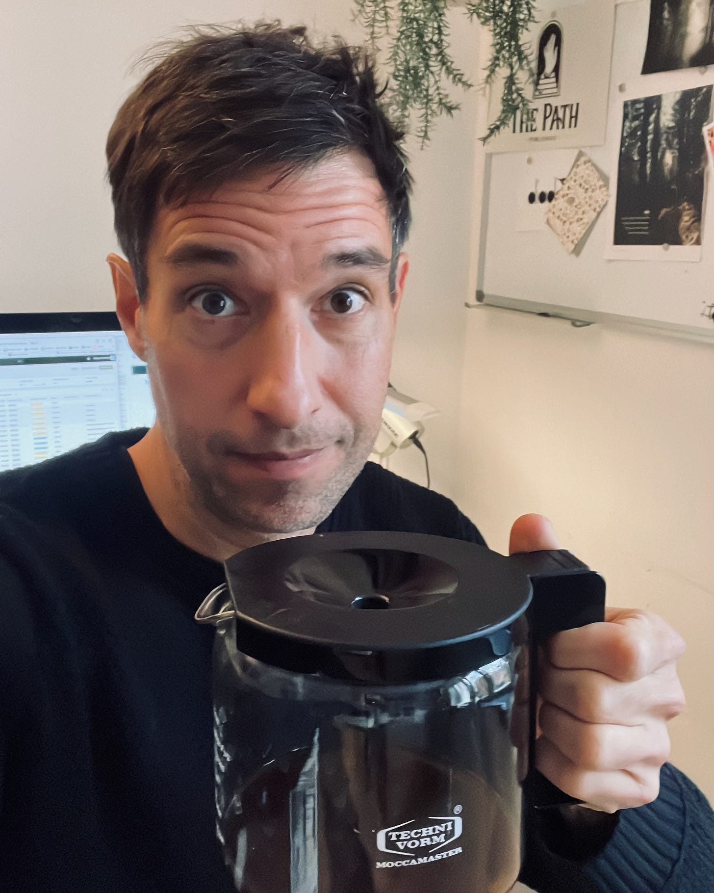 The author holding a can of coffee in his hand