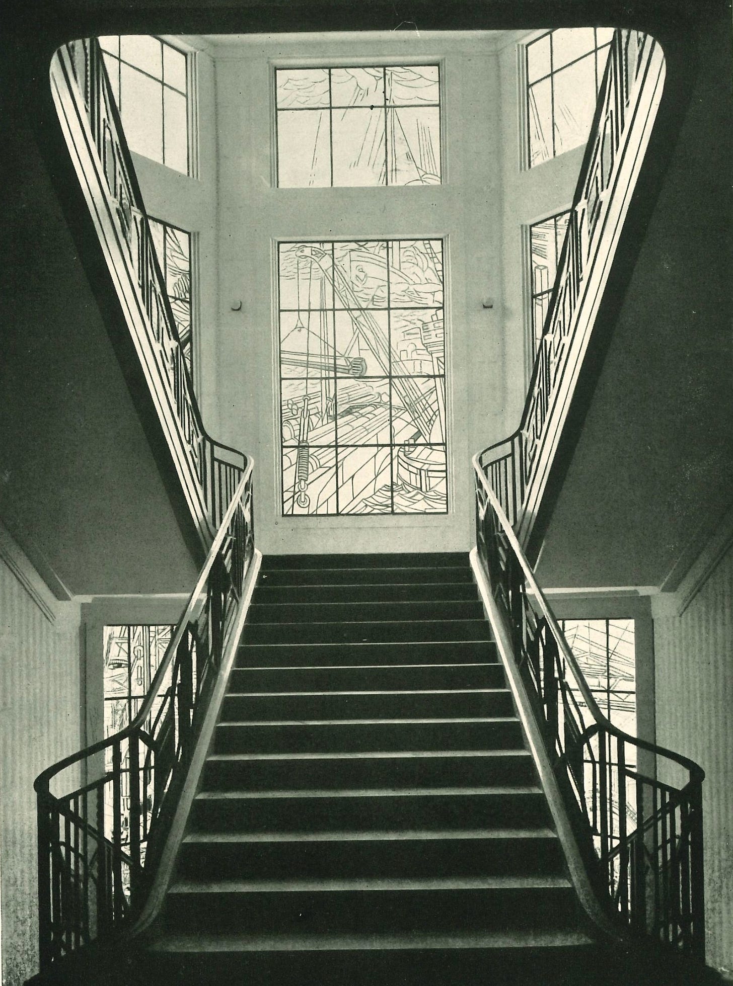 The great staircase of PAM SA headquarters, pictured in 1928, with stain glass windows by Jacques Gruber, here on the third landing, depicting the unloading of pipes from a ship in a distant country. The great staircase of PAM SA headquarters, pictured in 1928, with stain glass windows by Jacques Gruber, here on the third landing, depicting the unloading of pipes from a ship in a distant country.