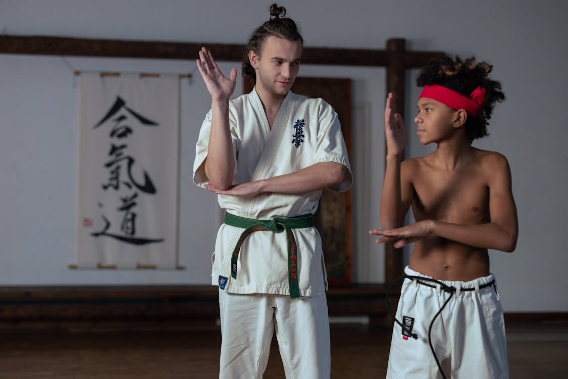 Trainer and Boy Practicing Martial Arts · Free Stock Photo