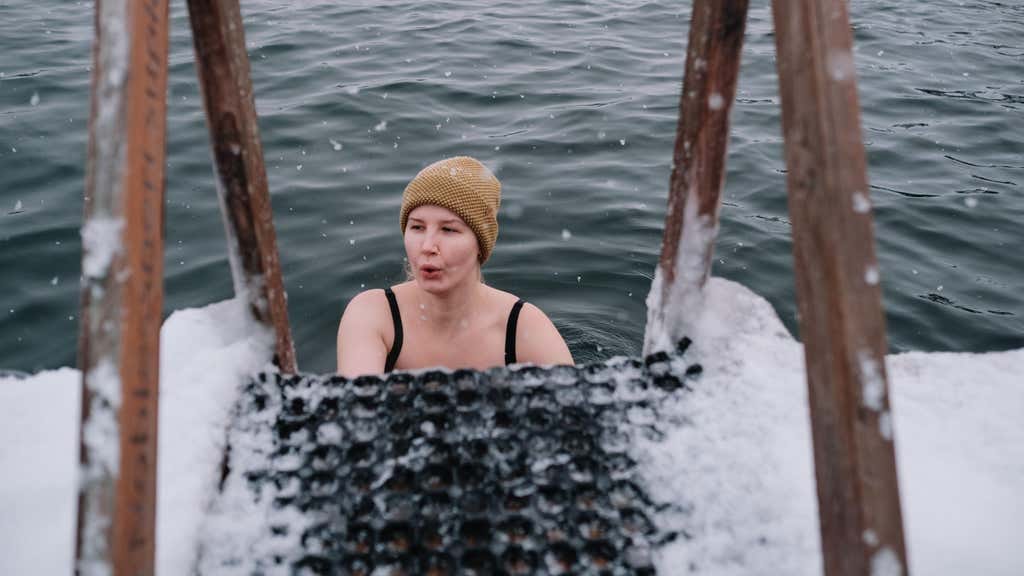 A woman swimming in a cold lake