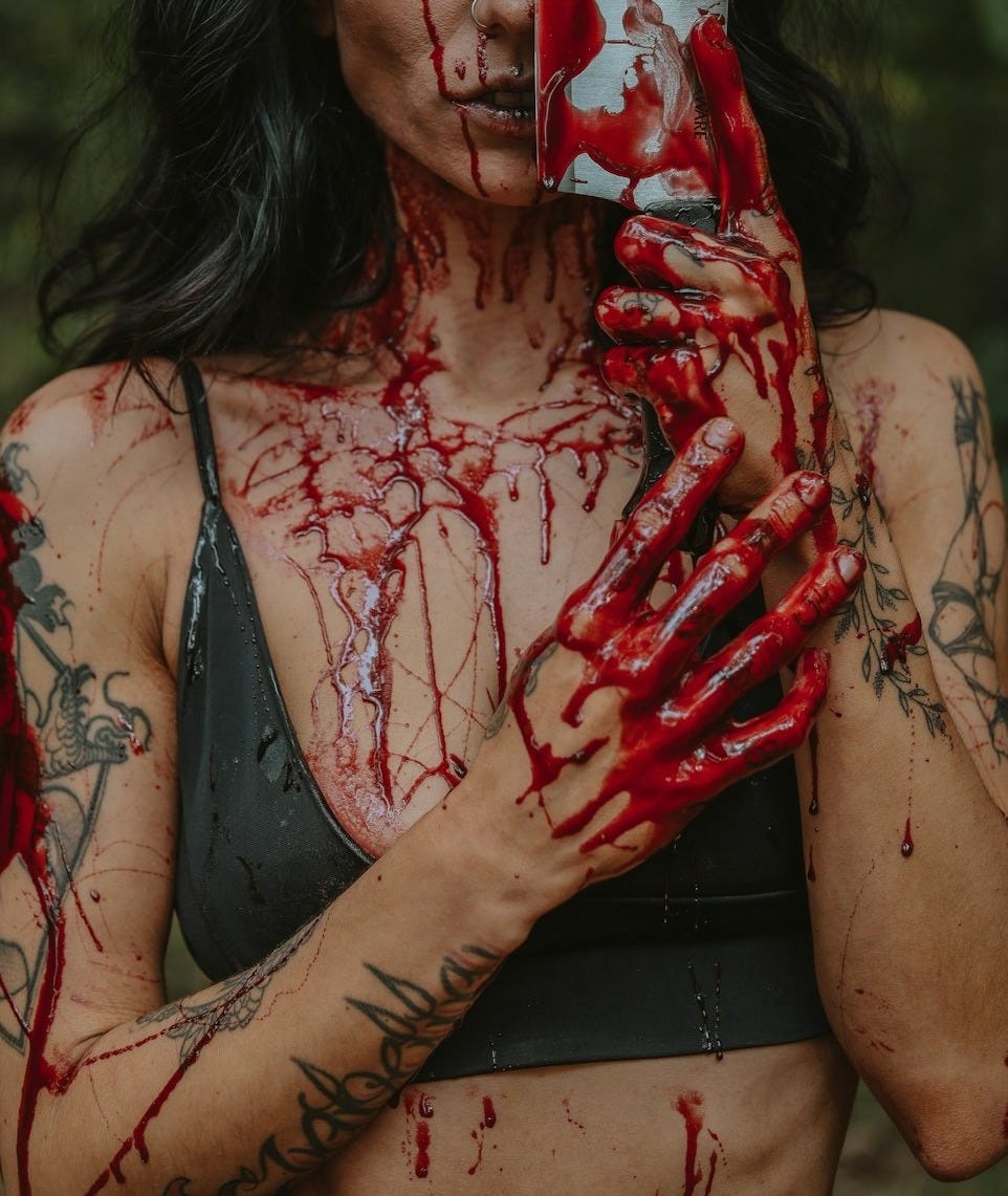 a woman holding a cell phone covered in blood