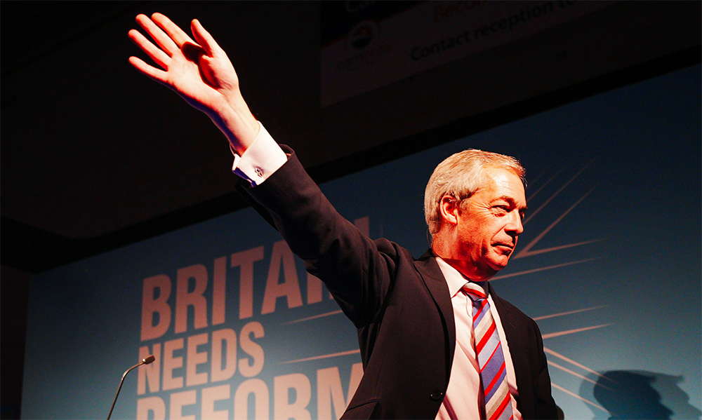 A person in a suit raising his hand
Description automatically generated A person in a suit raising his hand
Description automatically generated