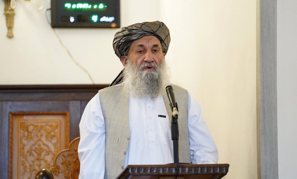 A person with a beard and a hat speaking into a microphone

Description automatically generated with low confidence