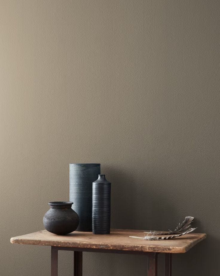 This may contain: two vases are sitting on a table next to each other in front of a wall