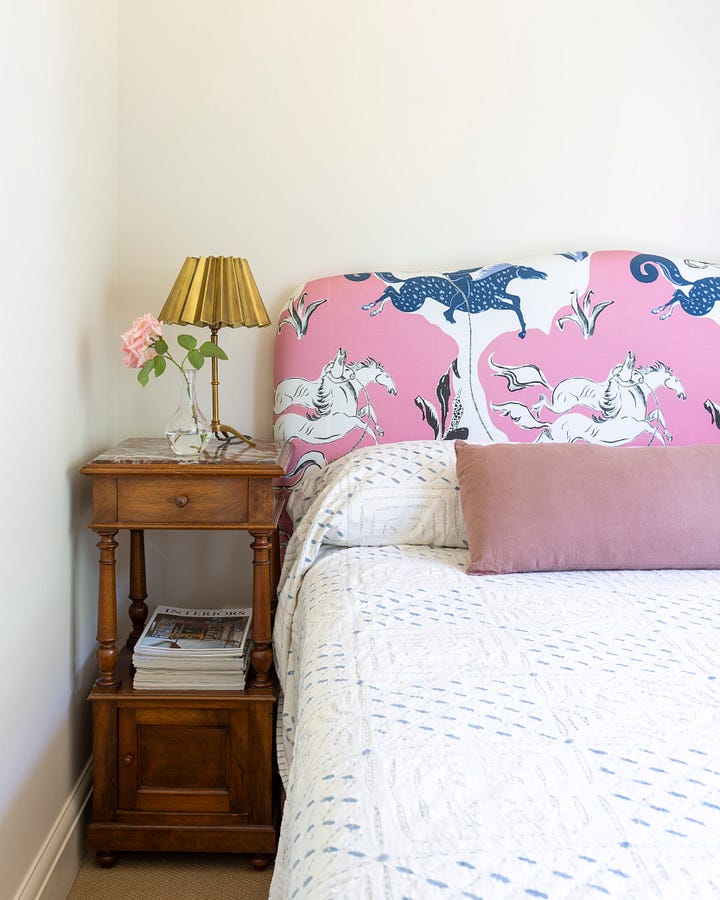 a wool banket, delft tile, pink radio and bed with brass lamp