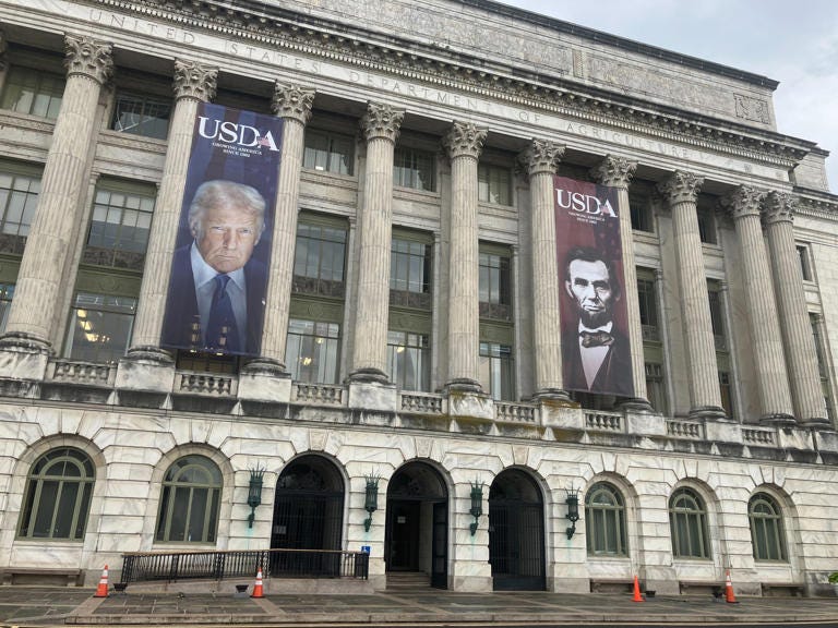 Large banners installed on the facade of the U.S. Department of Agriculture show President Donald Trump and President Abraham Lincoln (Eric Garcia/The Independent)