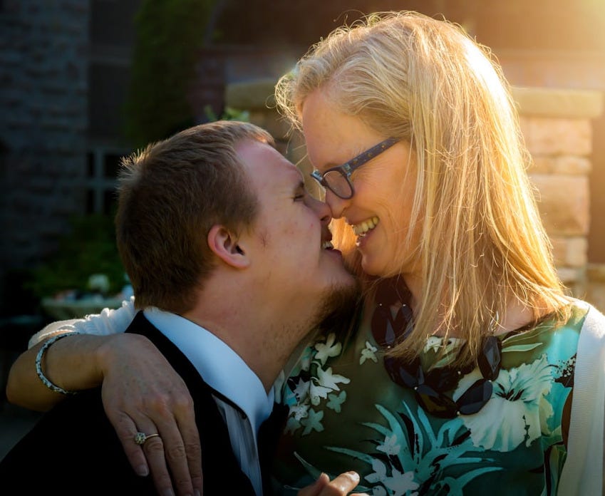 smiling couple kissing during daytime